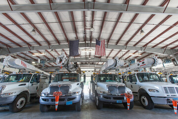 Power company bucket lift trucks in maintenance garage