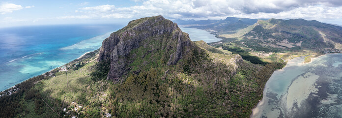 Panoramic aerial view of Mauritius island with famous Le Morne Brabant mountain, beautiful beach, blue lagoon and landscape in the UNESCO World Heritage Site