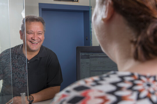 Female service agent talking to a customer in customer service center of electric power plant