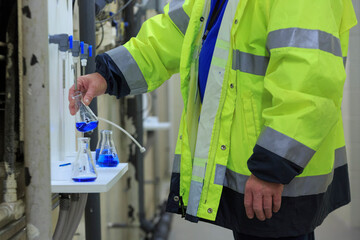 Water department engineer testing water sample