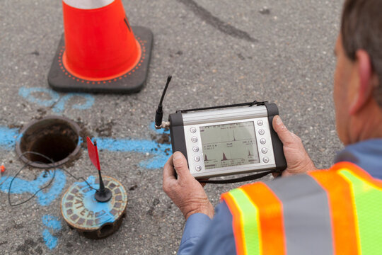 Water department technician reading a flow sensor