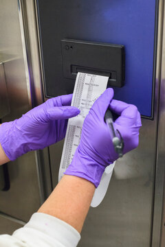 Lab technician collecting data on sterilization