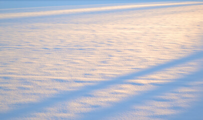 Still expanse of snow at sunset.