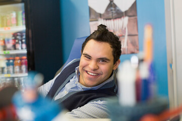 Middle Eastern man with Down Syndrome smiling at work