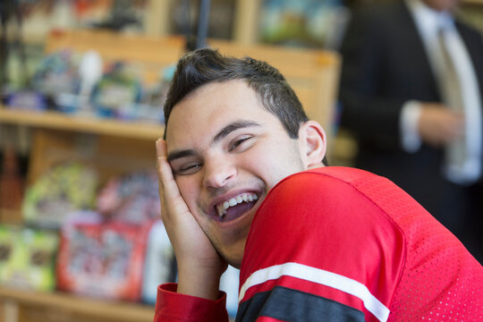 Middle Eastern man with Down Syndrome smiling at work
