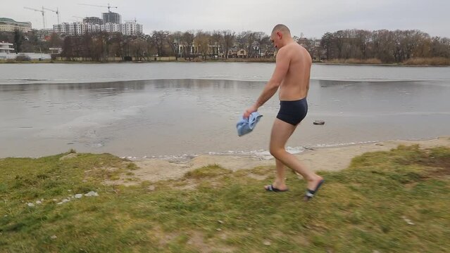  Bathing in icy water. Diving into icy water. Ice Swimming. Bathing in the ice-hole. Frozen river. 