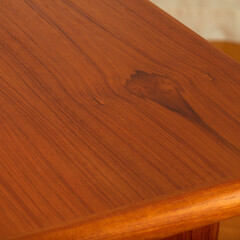 Wood grain from a vintage teak mid-century modern table. Natural texture background.