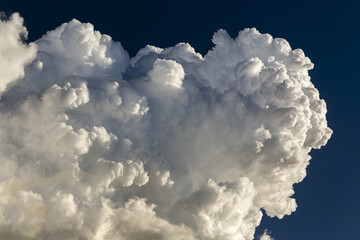 Close-up of large storm cloud formation in blue sky; Calgary, Alberta, Canada
