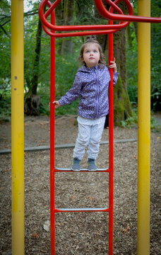 Preschool girl at a playground; North Vancouver, British Columbia, Canada