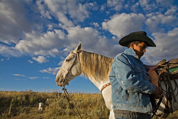 A once wild horse now works the Wyoming range with a sheepherder; Savery, Wyoming, United States of America