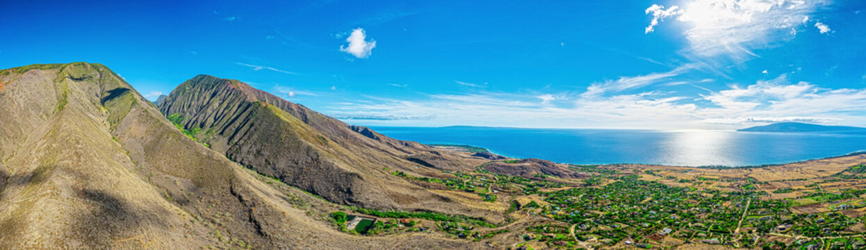Aerial of the West Maui Mountains over Launiupoko with the sunlight reflecting on the Pacific Ocean in Lahaina; Maui, Hawaii, United States of America
