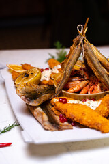 Shrimp and fish in assortment on a festive white plate