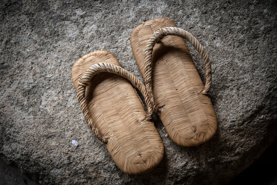 Traditional Japanese sandals on a rock; Miyajima, Japan