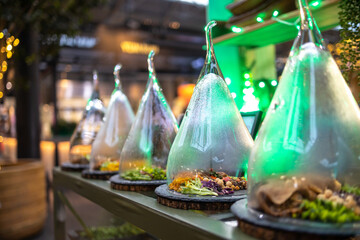Falafel tortillas, legumes, salad under a glass jar for sale at the food market