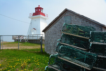A Canadian coastguard lighthouse, Neil's Lighthouse, serves as an ice cream shop in the summer.; Neil's Harbor, Cape Breton Highlands National Park, Nova Scotia, Canada.