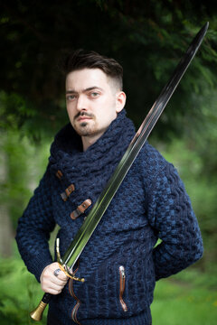 Portrait of a young man holding a sword; Bothell, Washington, United States of America
