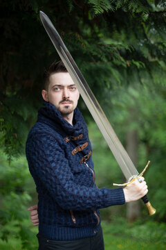 Portrait of a young man holding a sword; Bothell, Washington, United States of America