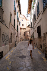 Fototapeta na wymiar young woman walking through the streets of mallorca