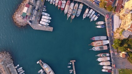 Fototapeta na wymiar Aerial view of amazing boats. Marina bay. Top view from drone of harbor with yacht, motorboat and sailboat. Seascape
