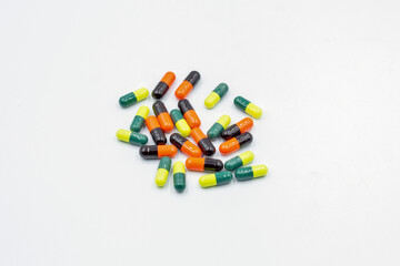 Different medical capsules closeup on white