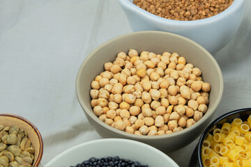 Yellow chickpeas in bowl. Various vegetarian organic products. Vintage view.