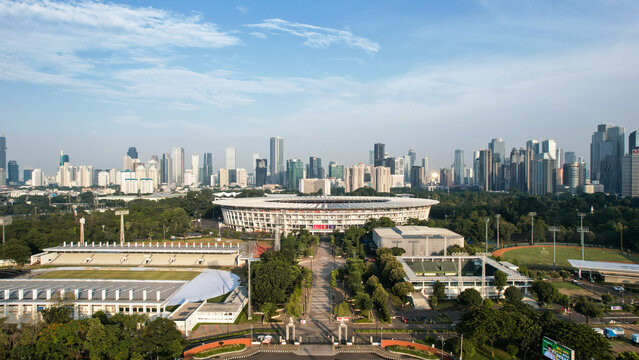 Aerial top down view of the Beautiful scenery of Senayan Stadium. with Jakarta cityscape background. Jakarta, Indonesia, December 21, 2022