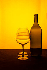 Still life with a wine bottle and glasses with liquid
