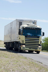 white cargo truck, from the front traveling along the route, cargo transportation carrying loads along the routes