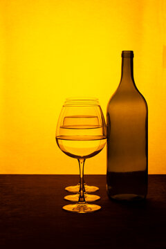 Still life with a wine bottle and glasses with liquid