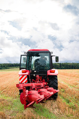 Fototapeta premium tractor with a large plow is ready to work in the field
