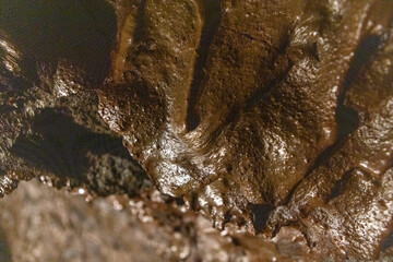 Exploring a volcanic cave in the Volcanic Caves Park at the foot of Villarrica volcano in Pucon, Chile 
