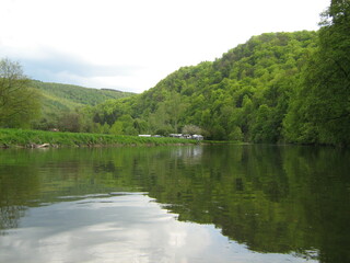 beautiful landscape of river semois in the belgian ardennes in springtime with big green hills next to the water