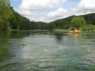 beautiful landscape of river semois in the belgian ardennes with a canoe and green mountains with trees