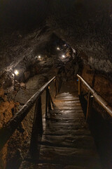 Exploring a volcanic cave in the Volcanic Caves Park at the foot of Villarrica volcano in Pucon,...