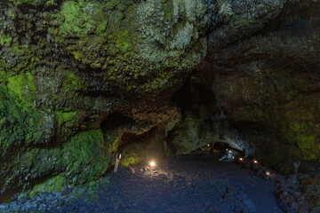 Obraz premium Exploring a volcanic cave in the Volcanic Caves Park at the foot of Villarrica volcano in Pucon, Chile 