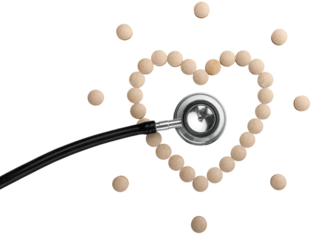 Pills in the shape of heart dropped with the medical stethoscope