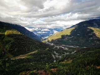 Aerial of Whistler mountain valley with low clouds
