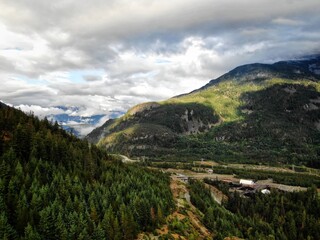 Naklejka premium Aerial of Whistler mountains with low clouds