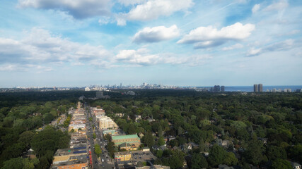 Obraz premium Aerial view over Bloor Street West in the Kingsway neighborhood of Toronto, Ontario, Canada. Looking southeast towards the downtown core Toronto skyline, Mimico and Lake Ontario. 
