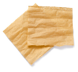 Baking paper isolated. Crumpled pieces of brown parchment or baking paper on white background. Top...