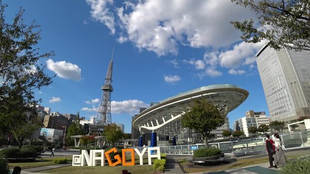 NAOGYA, JAPAN - OCTOBER 2022 : View of HISAYA ODORI PARK and SAKAE area in sunny daytime. Busy central downtown area in Nagoya city. Time lapse shot. Travel and tourism concept video.