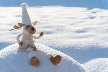 Figure of chrismas deer on snowy field. Concept of funny winter day and christmas spirit.