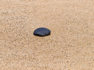 Fototapeta na wymiar Playa Del Pozo stone on sandy beach