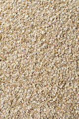 Top view of dry uncooked instant oat flakes or cereals as a background. Flat lay.