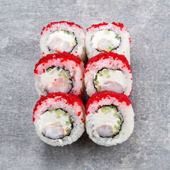 Maki sushi rolls with shrimp, cucumber, cream cheese and red flying fish caviar.