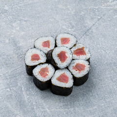 Set of mini sushi rolls with tuna fish, rice and nori.
