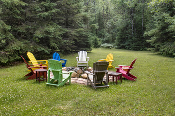 colorful Adirondack chairs around fire pit in backyard