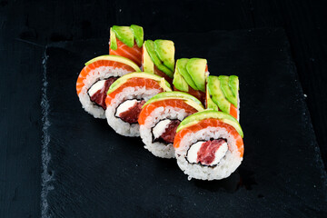 Set of sushi rolls with tuna, salmon, cream cheese and avocado.