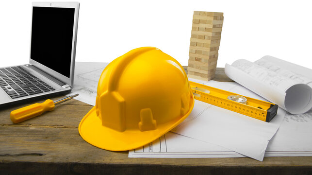 Blueprints and tools with hardhats on construction blueprint