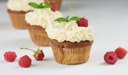 Baked cupcakes with white butter cream on the table, delicious dessert